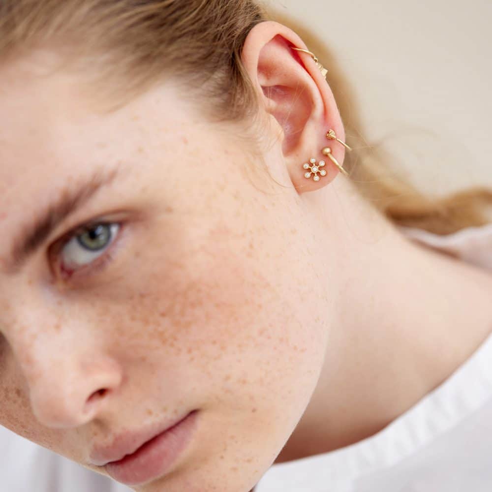 Model wearing different Line & Jo gold earrings
